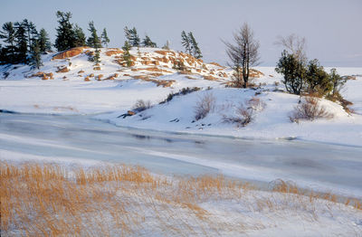 Scenic view of snow covered land against sky