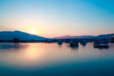 Scenic view of lake against sky during sunset