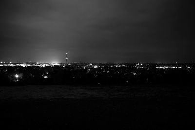 Illuminated city against sky at night