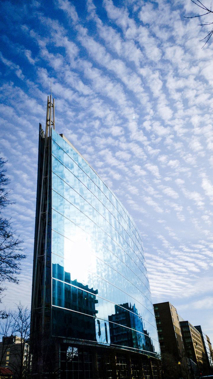 LOW ANGLE VIEW OF MODERN BUILDINGS AGAINST SKY IN CITY