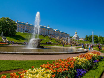 Water fountain in city against clear sky