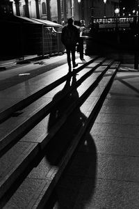 Rear view of man walking on footpath