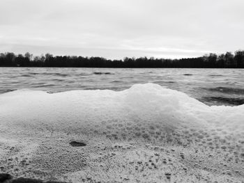 Scenic view of snow covered land against sky