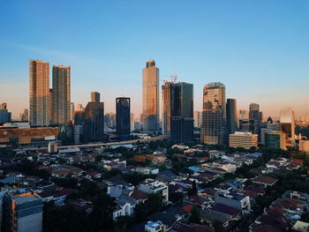 Modern buildings in city against clear sky