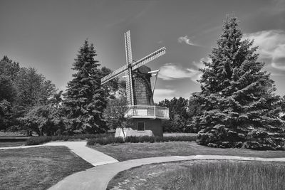 Traditional windmill on field against sky