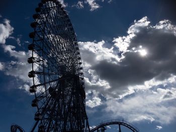 Low angle view of ferris wheel against sky