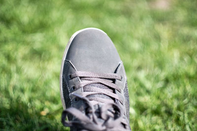 Close-up of shoes on field