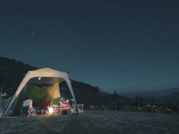 Tent on field against sky at night