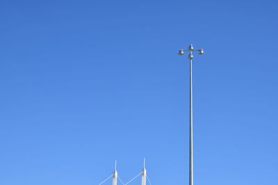 Low angle view of street light against clear blue sky