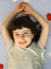 Portrait of smiling girl lying on bed