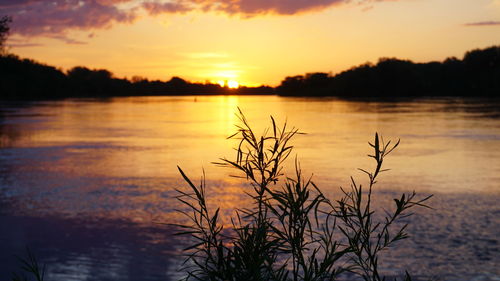 Scenic view of lake against romantic sky at sunset