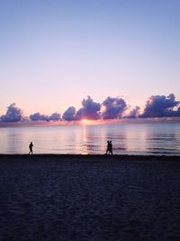 Silhouette of people at sunset