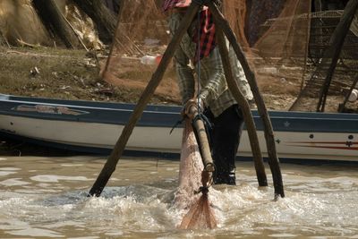 Man feeding horse in sea