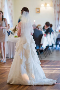 Rear view of bride standing at wedding ceremony