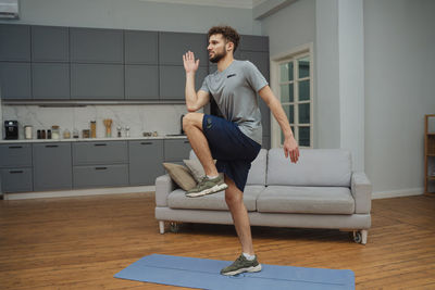 Portrait of young woman exercising at home