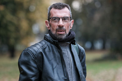 Mature man wearing jacket standing outdoor