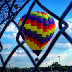 Low angle view of colorful balloons against blue sky