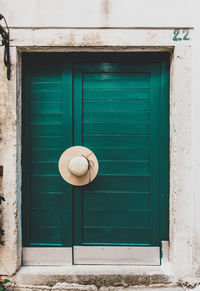 Old green wooden door, hat, minimalism, minimalist architecture, entrance.