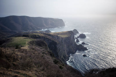 Scenic view of sea and rocks against sky