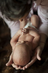 High angle view of baby holding hands