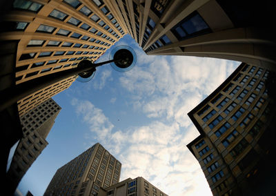 Low angle view of buildings against cloudy sky