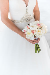 Midsection of woman holding flower bouquet