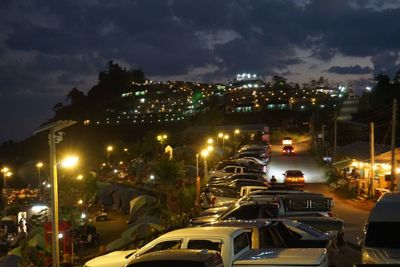 Illuminated city against sky at night