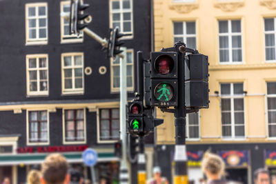 Close-up of road sign on street in city