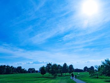 Scenic view of grassy field against cloudy sky
