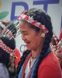 Portrait of smiling woman with red flower