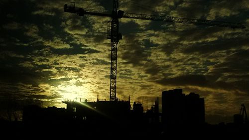 Low angle view of silhouette city against sky at sunset