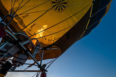 Low angle view of hot air balloon against clear blue sky