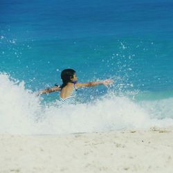 Full length of boy enjoying at beach