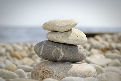 Close-up of stone stack on pebbles at beach