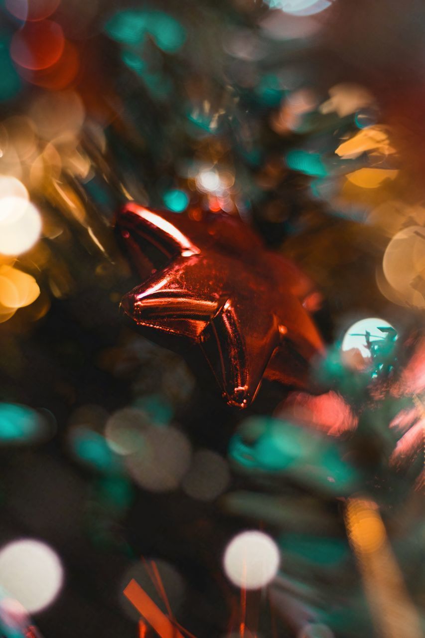 CLOSE-UP OF ILLUMINATED CHRISTMAS TREE AT NIGHT