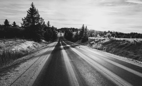 Empty road against sky in winter