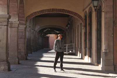 Full length of man standing in colonnade