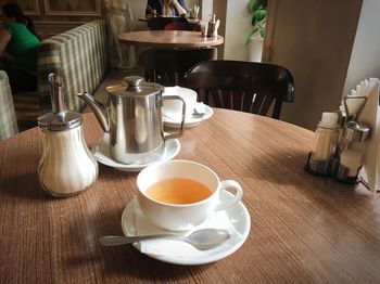 Coffee cup and tea on table