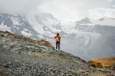 Woman with backpack on mountain background. top of gornergrat, zermatt, swiss. hiking in alps