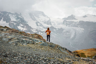 Rear view of man walking on mountain