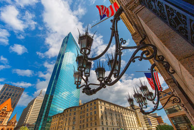 Low angle view of flags and buildings against sky