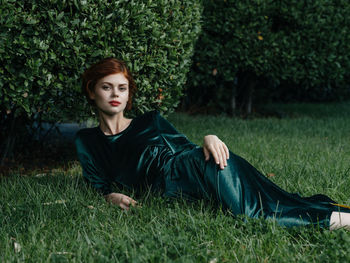 Portrait of woman sitting on grass