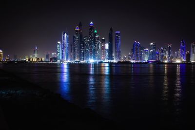 Illuminated city at waterfront