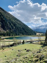 Scenic view of lake and mountains against sky