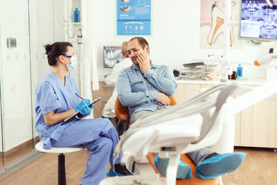 Dentist talking with patient at clinic