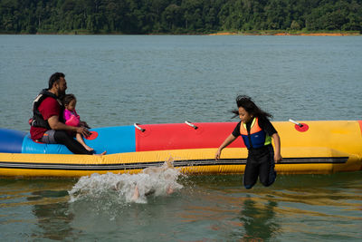 Full length of woman on boat in lake