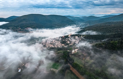 Panoramic view of the old village of mirmande. aerial photo in the morning in the thick fog rising 