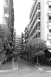 Street amidst buildings against clear sky
