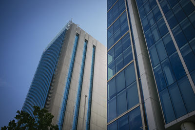 Low angle view of modern office building against clear sky