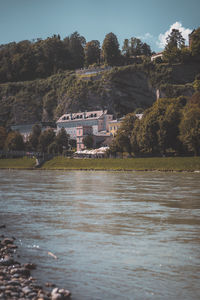 River flowing amidst buildings against sky